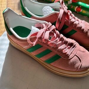 Adidas platform Gazelles pink with green stripes.